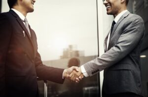 corporate-businessmen-shaking-hands-min